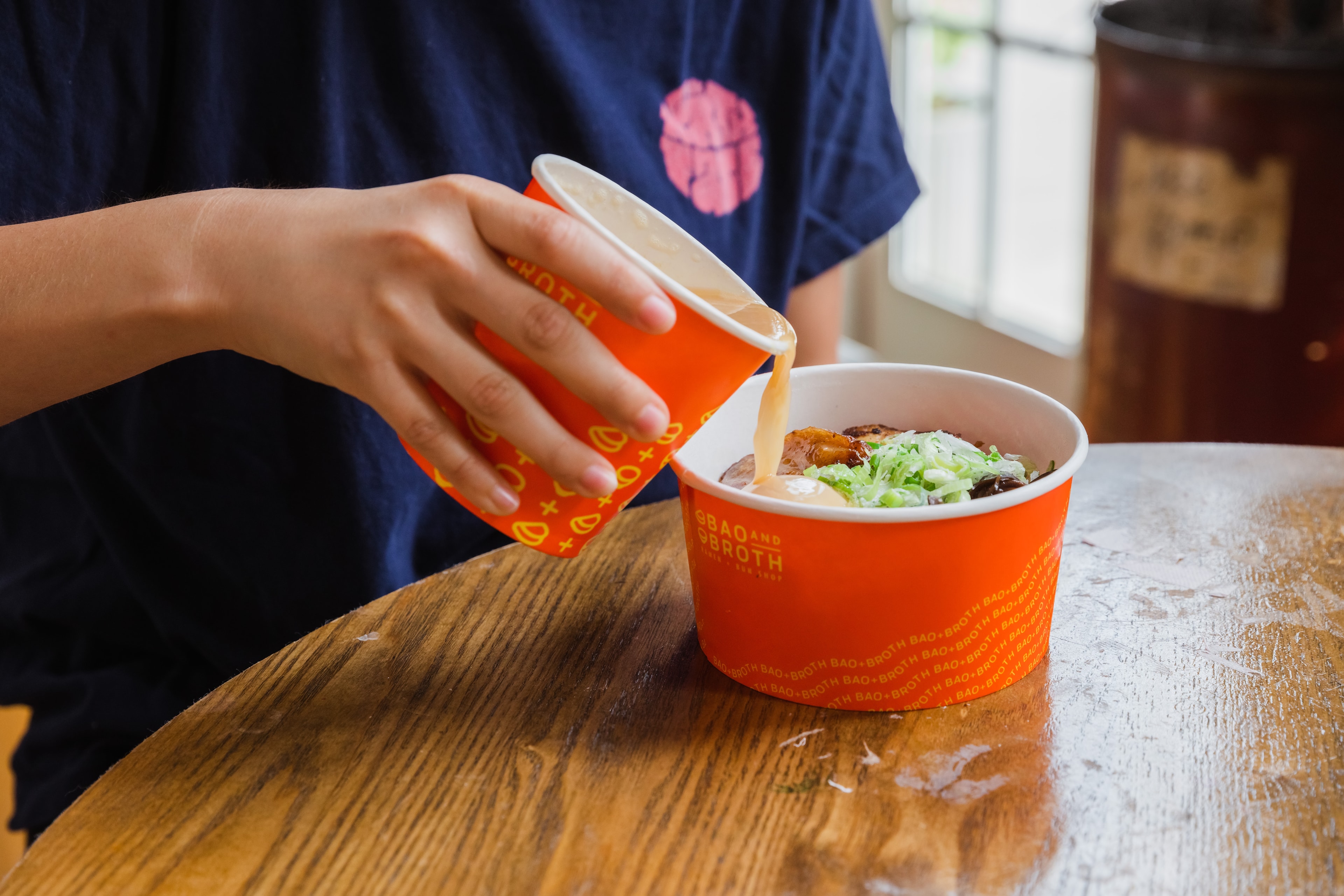 Ramen noodles lifted with chopsticks